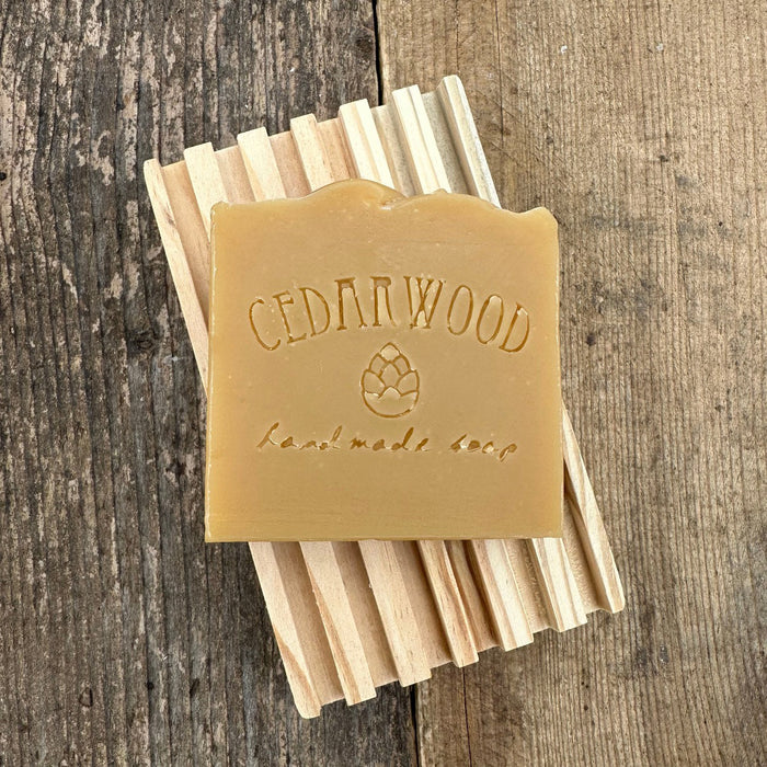 Citrus Clove handmade soap bar on wood soap dish