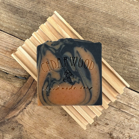 Orange and black Halloween handmade bar soap on wood soap dish