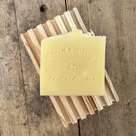 Lime coconut handmade soap bar on wood soap dish