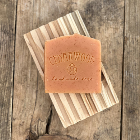 Orange grapefruit handmade soap bar on wood soap dish