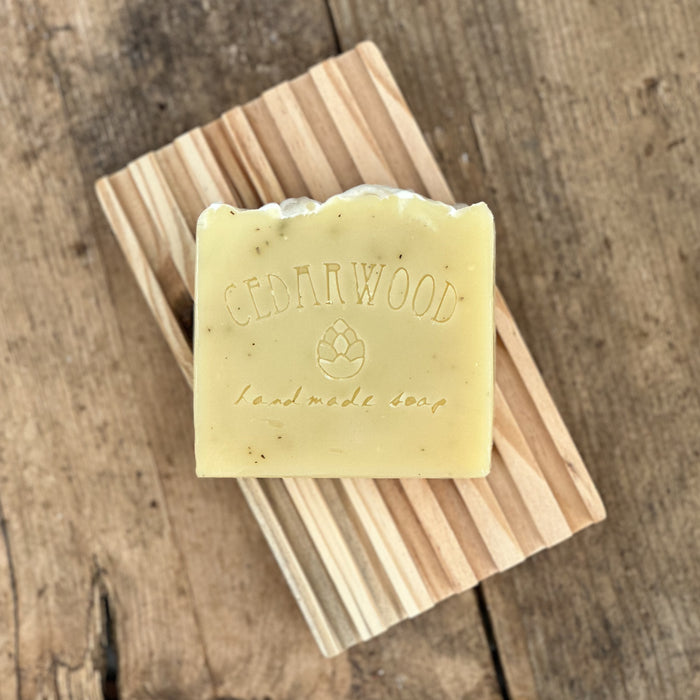 Rosemary handmade soap bar on wood soap dish