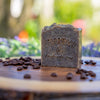 Handmade bar of Java soap on wood surface with coffee beans