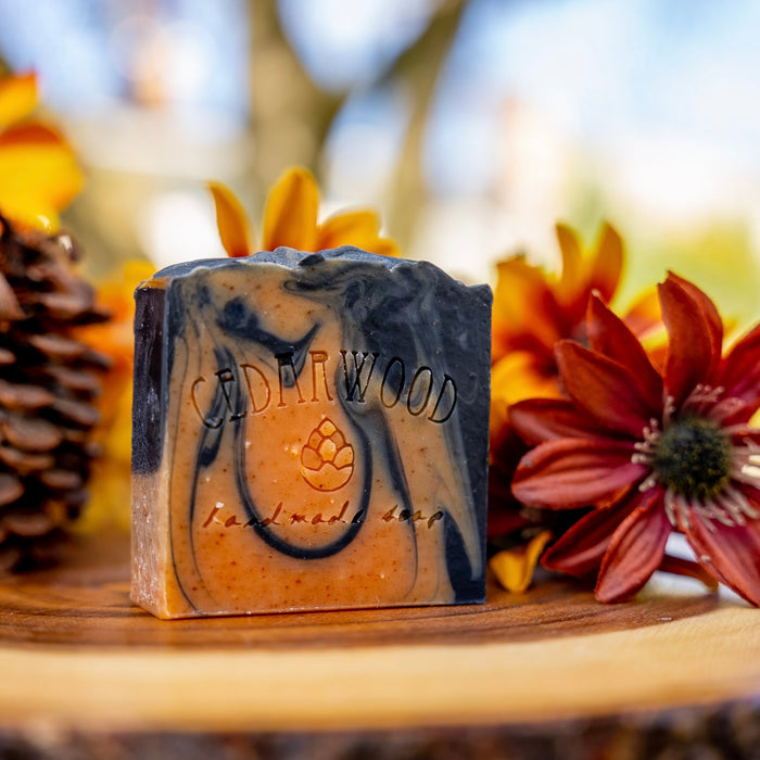 Handmade bar of Sorcerer Soapreme soap surrounded by fall flowers