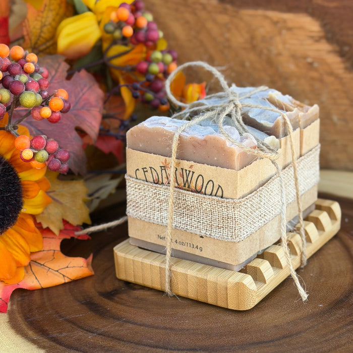 Four handmade fall soaps on bamboo soap with with fall decor