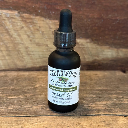 Black glass bottle of Cedarwood Bergamot beard oil