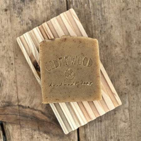 Handmade Cinnamon Oatmeal soap bar on wood soap dish 