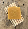 Handmade lemongrass IPA soap on wood soap dish 