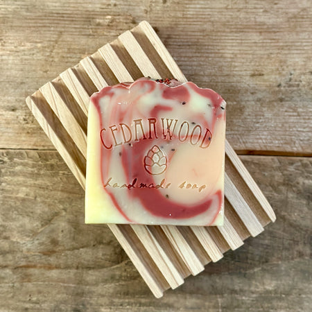 Handmade cherry blossom bar soap on wood soap dish